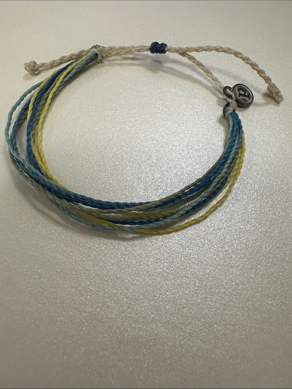 NWOT Pura Vida Colorful Twine Bracelet with Logo Metal Charm-Blue, Yellow, Green